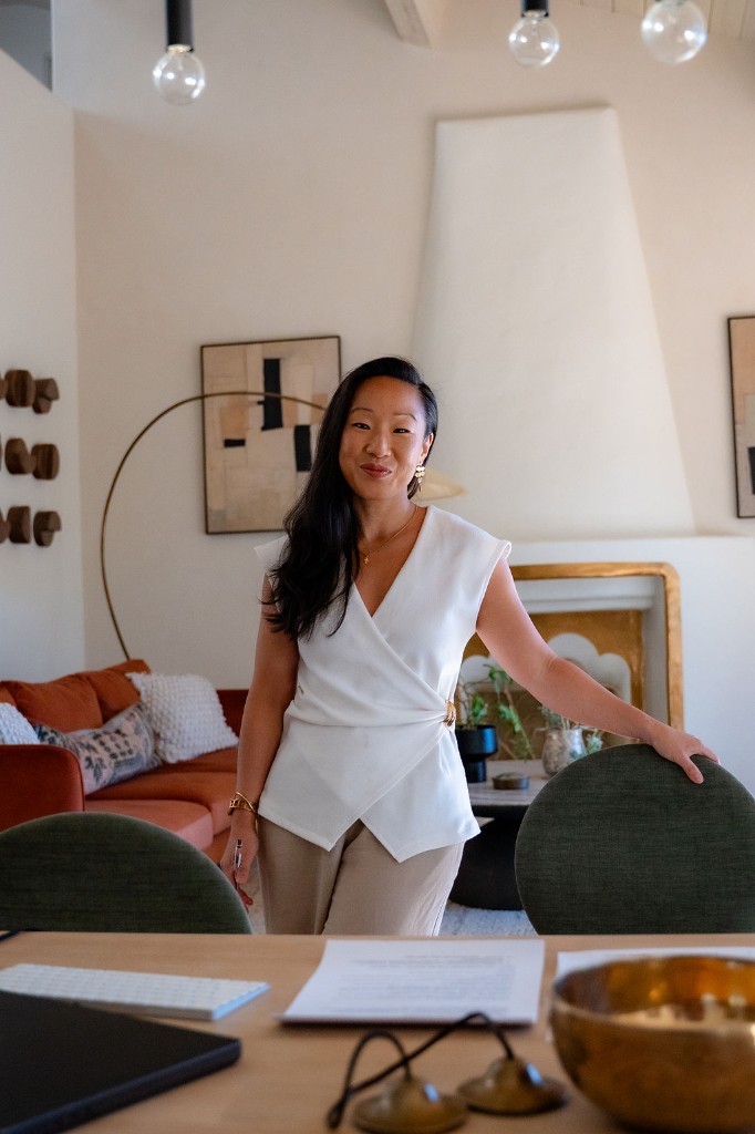 Victoria Grace standing in her studio beside a singing bowl